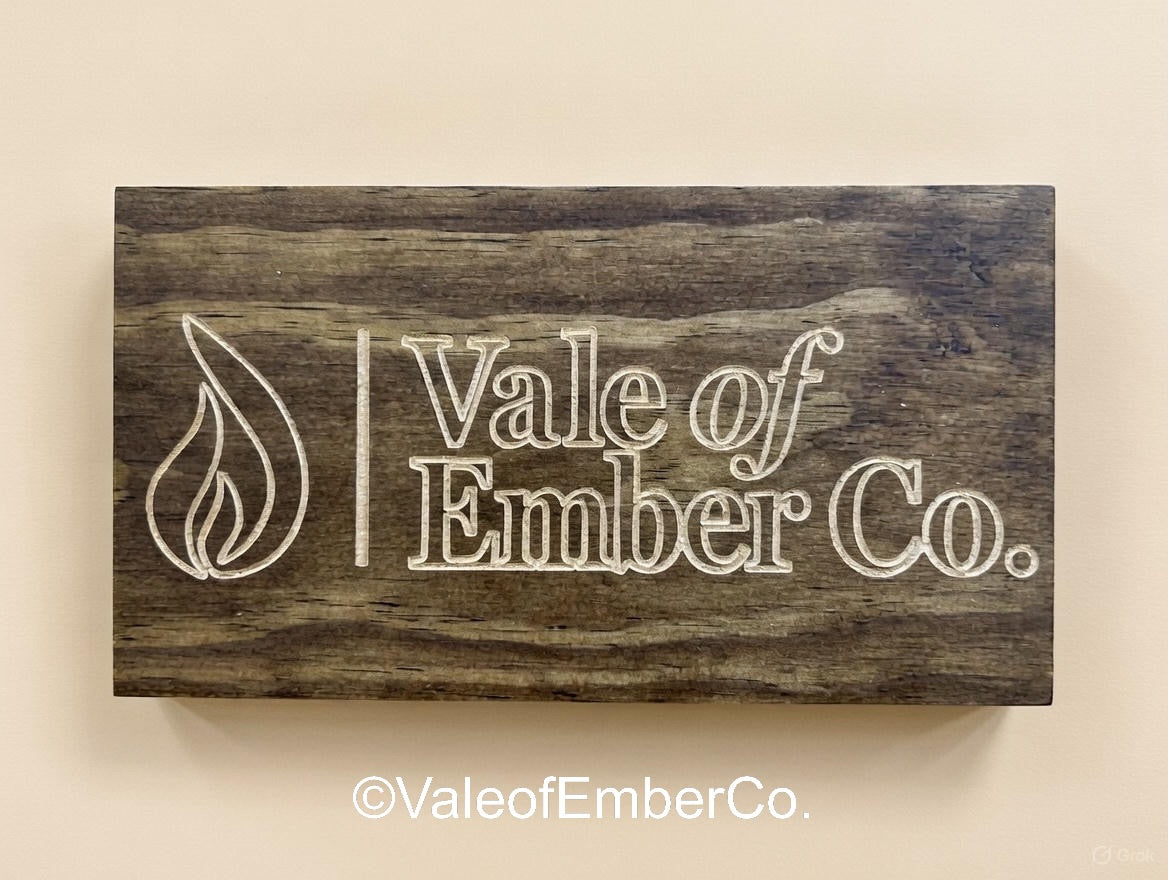 Wooden sign with 'Vale of Ember Co.' branding on a beige background